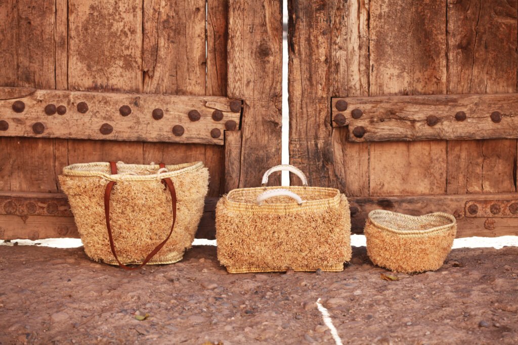 Handwoven baskets in front of a wooden door